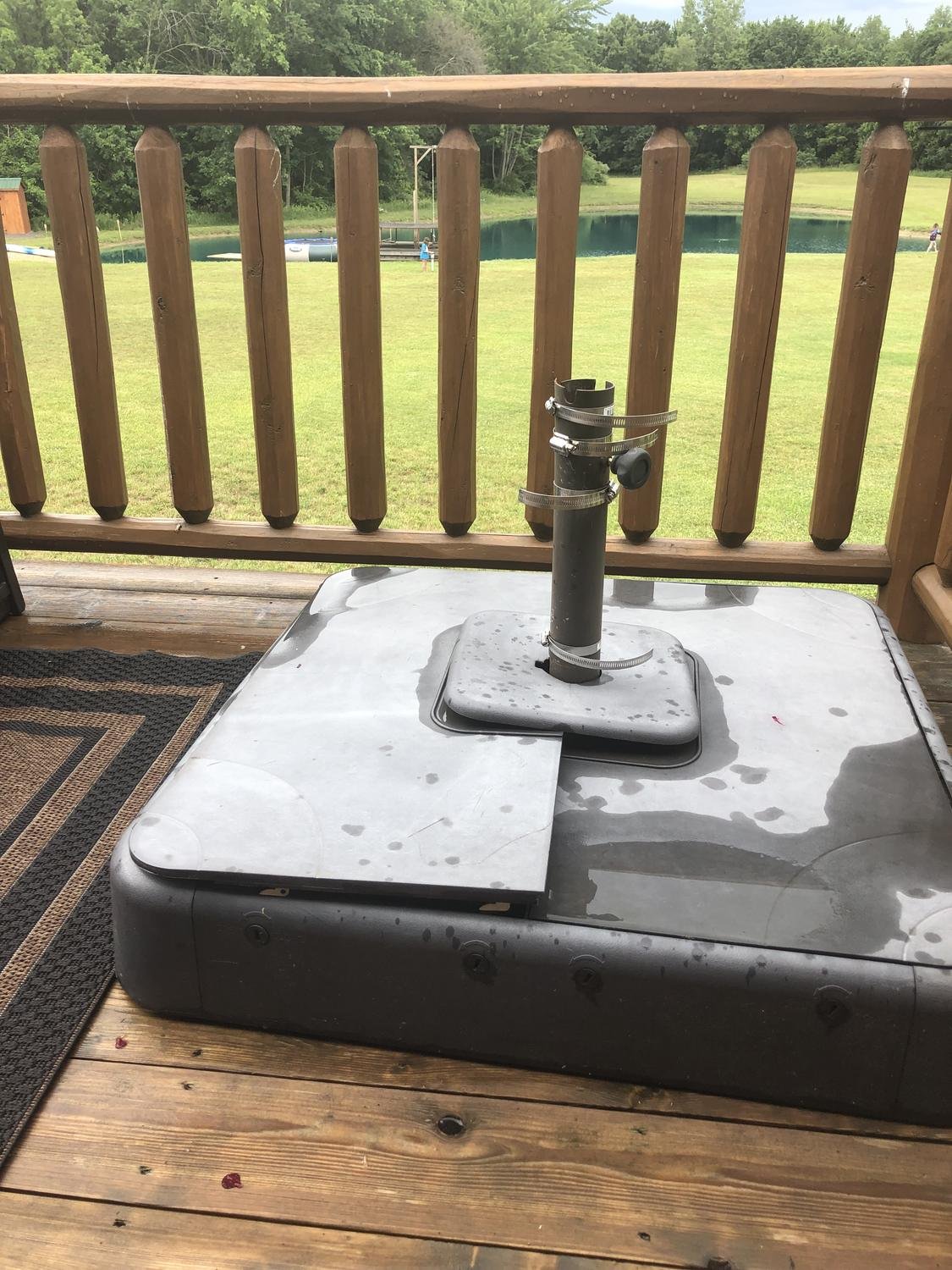 Old heavy plastic umbrella base with hose clamps
