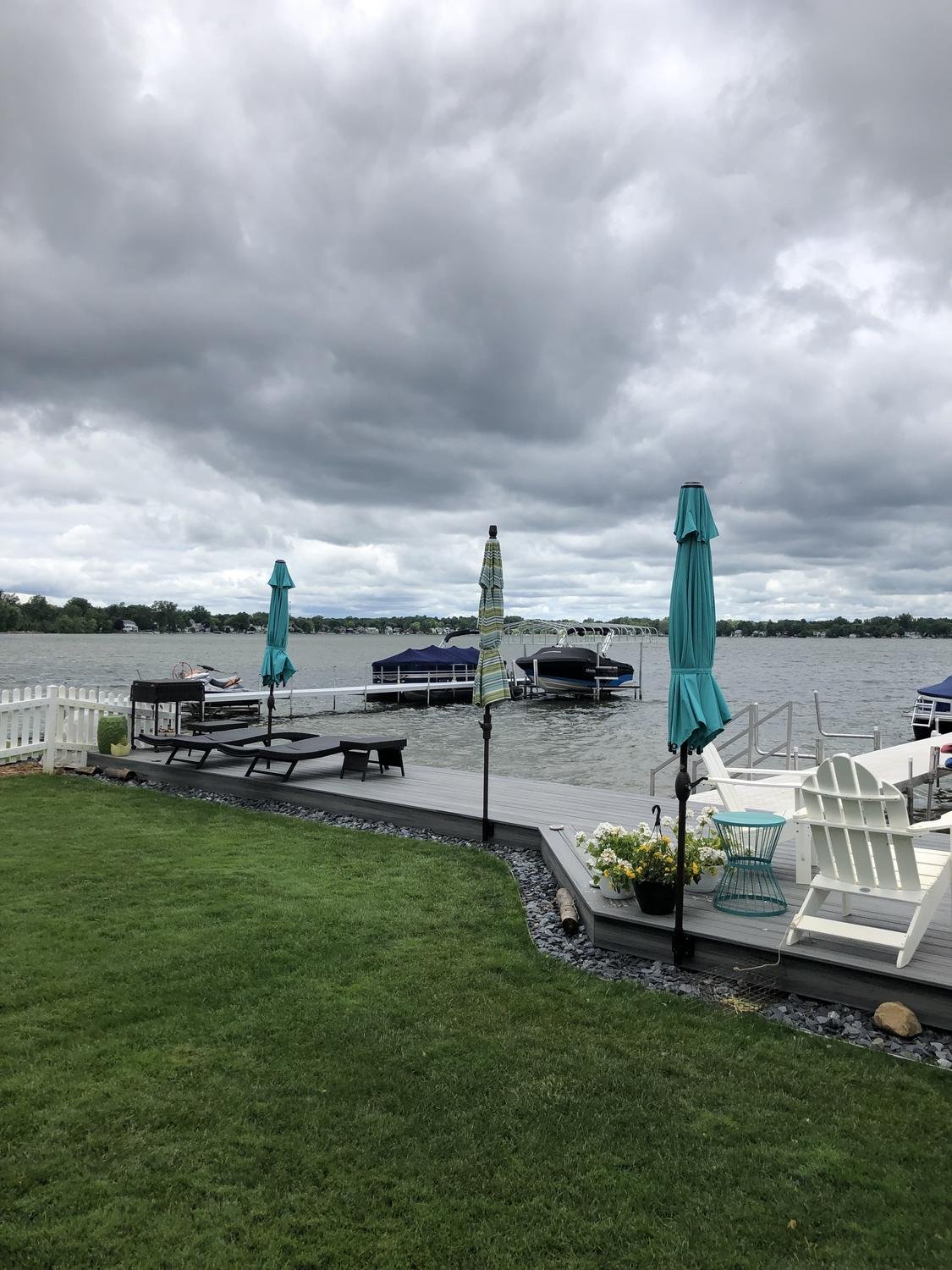Umbrellas standing firm on a deck under storm clouds